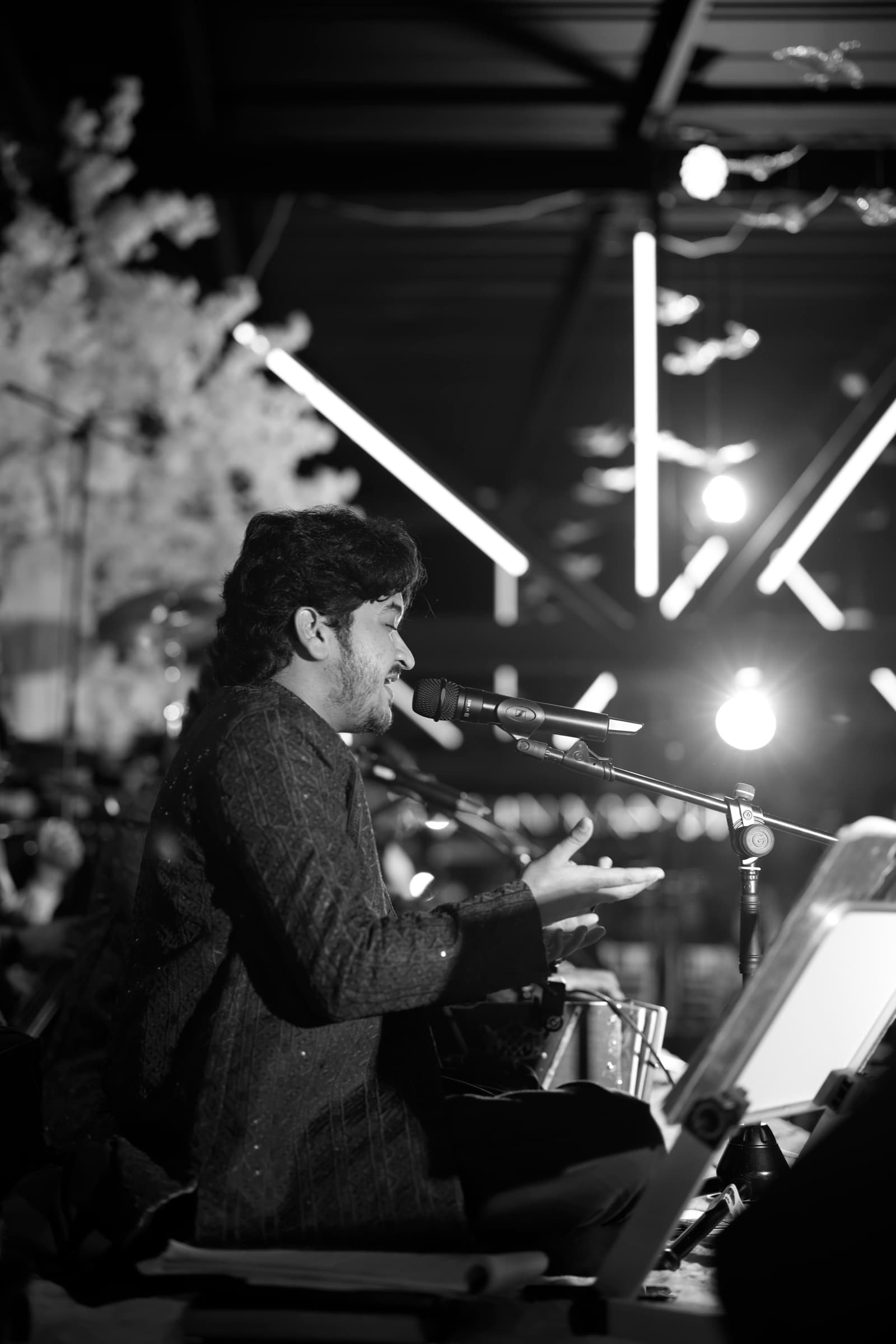 Qawwal singer performing, in black and white