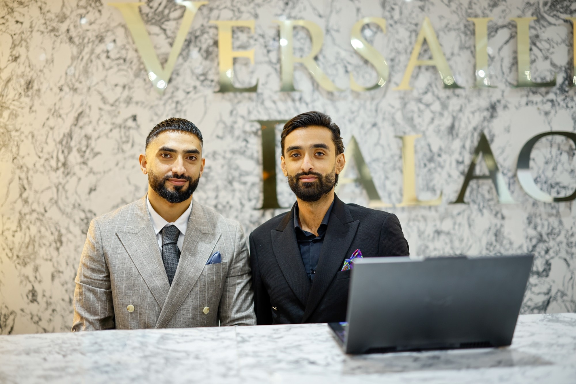 Two members of the Excellency team at the Versailles Palace reception desk